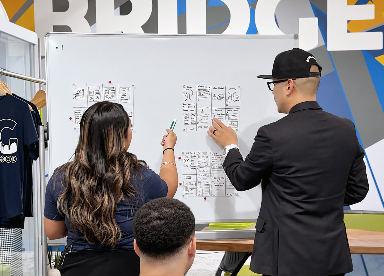 Shaun Tai mentoring UX design apprentices during a collaborative workshop.