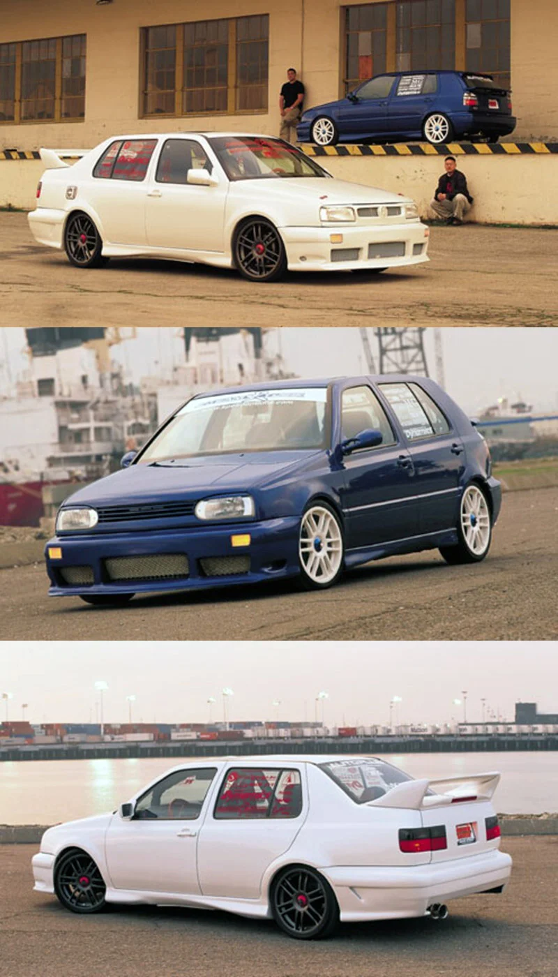 Three Volkswagen Jetta and Golf hatchbacks sit on pavement, two white sedans and one navy hatch, with a man leaning against a yellow-striped concrete wall beside a navy car and another man sitting on the ledge.